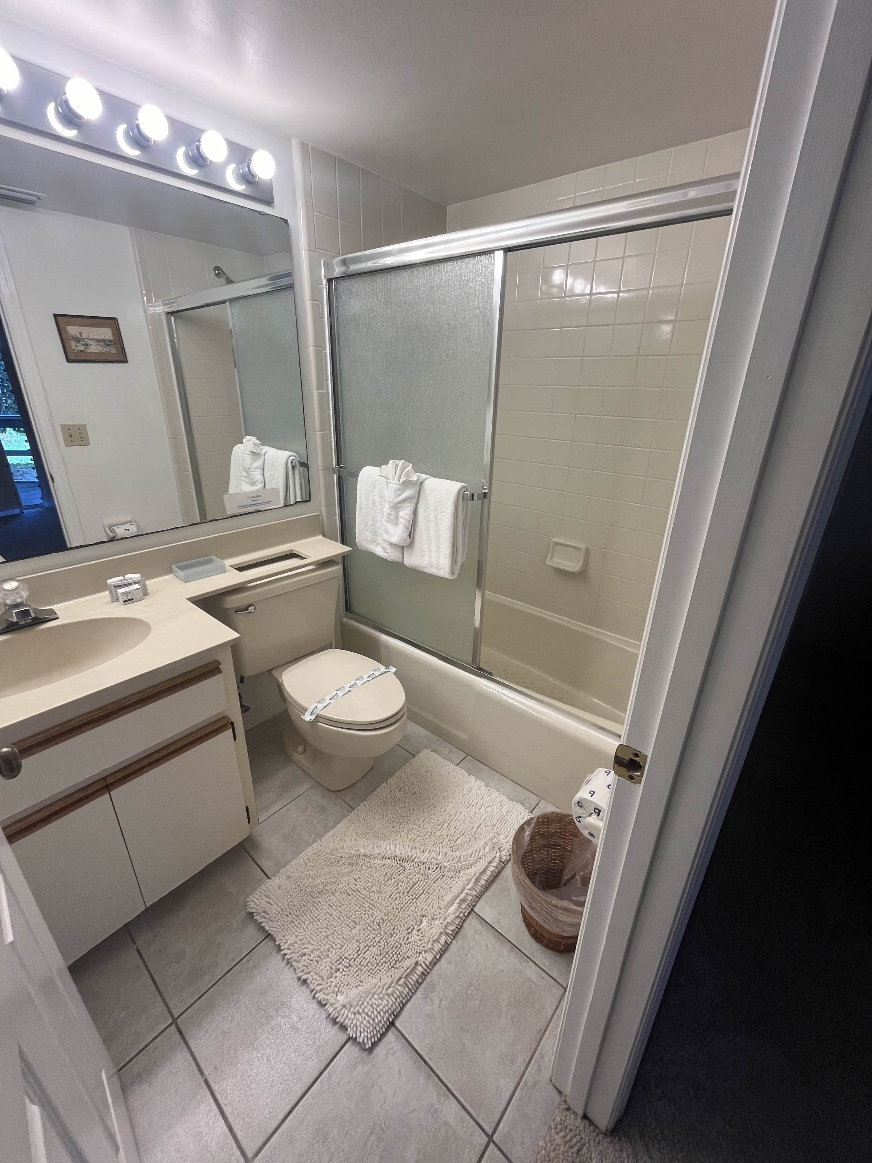 Pristine vacation rental bathroom with polished fixtures after professional cleaning